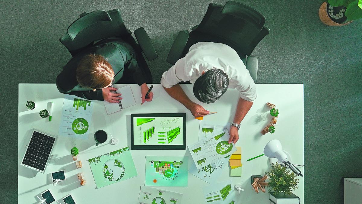 Two people sitting at a desk reading data