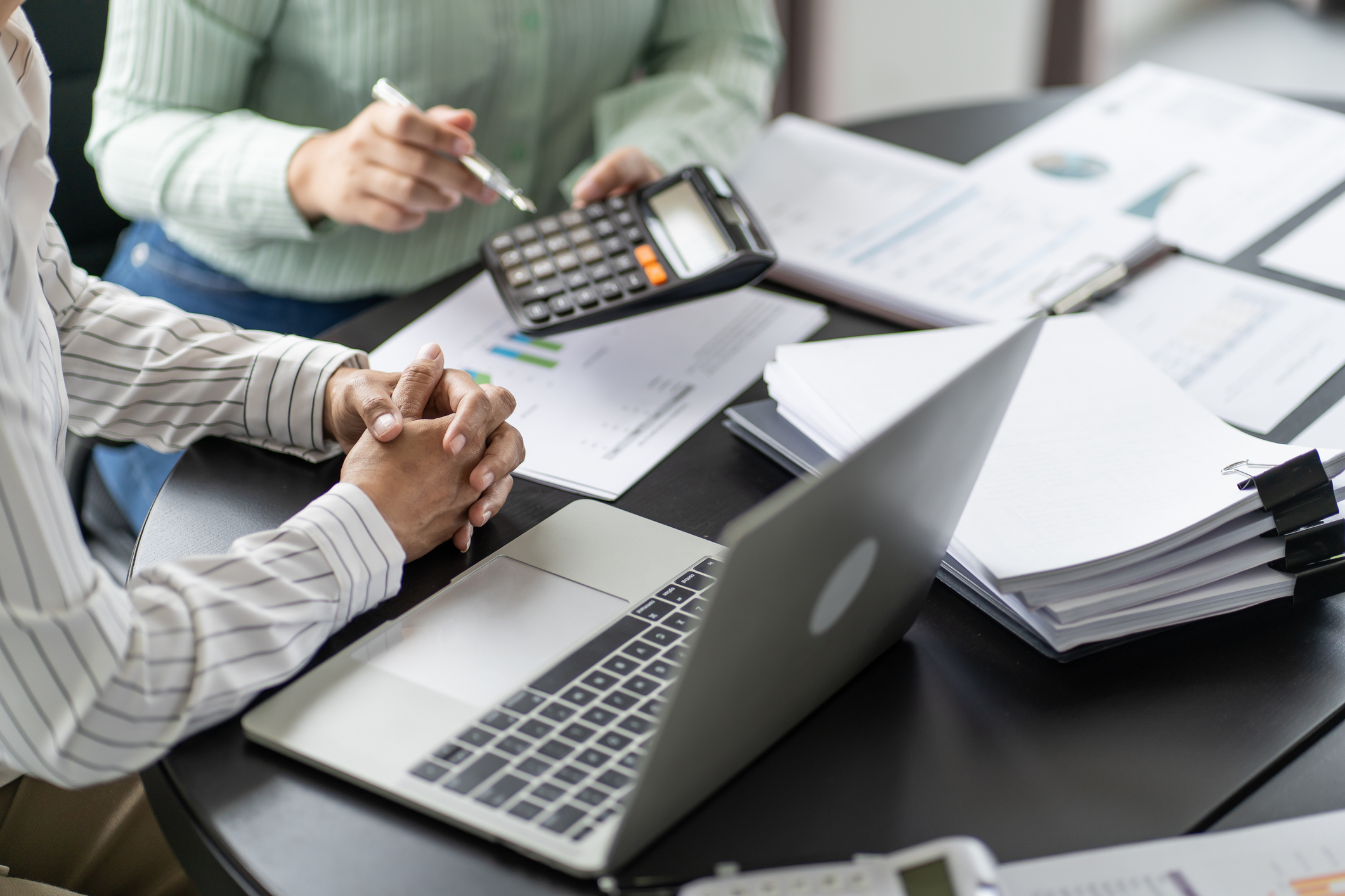 Two people crunching numbers at a desk