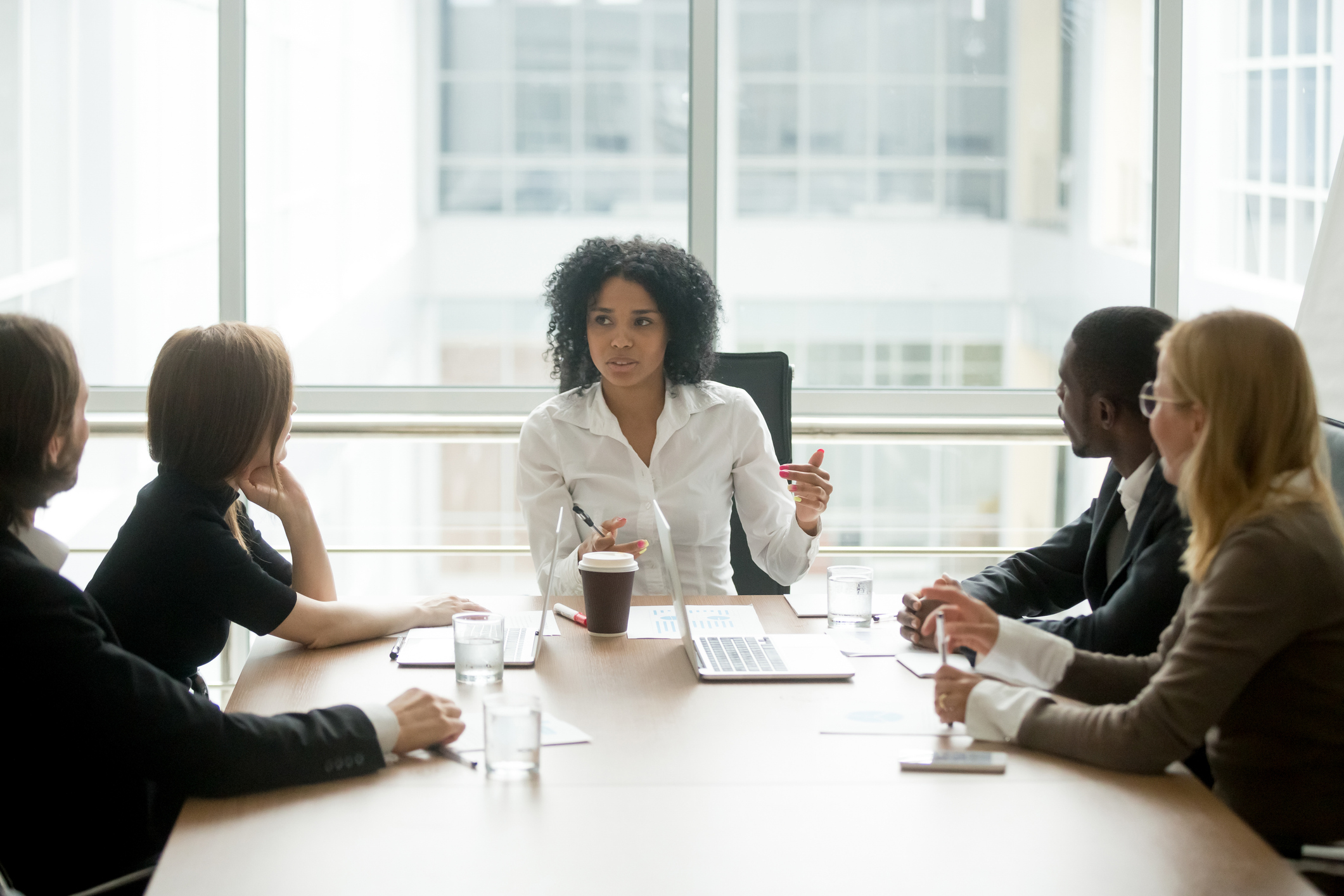 Woman leading a boardroom meeting with colleagues