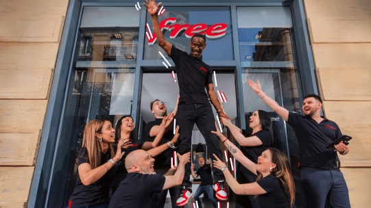 A man raising his right hand in front of a group of people